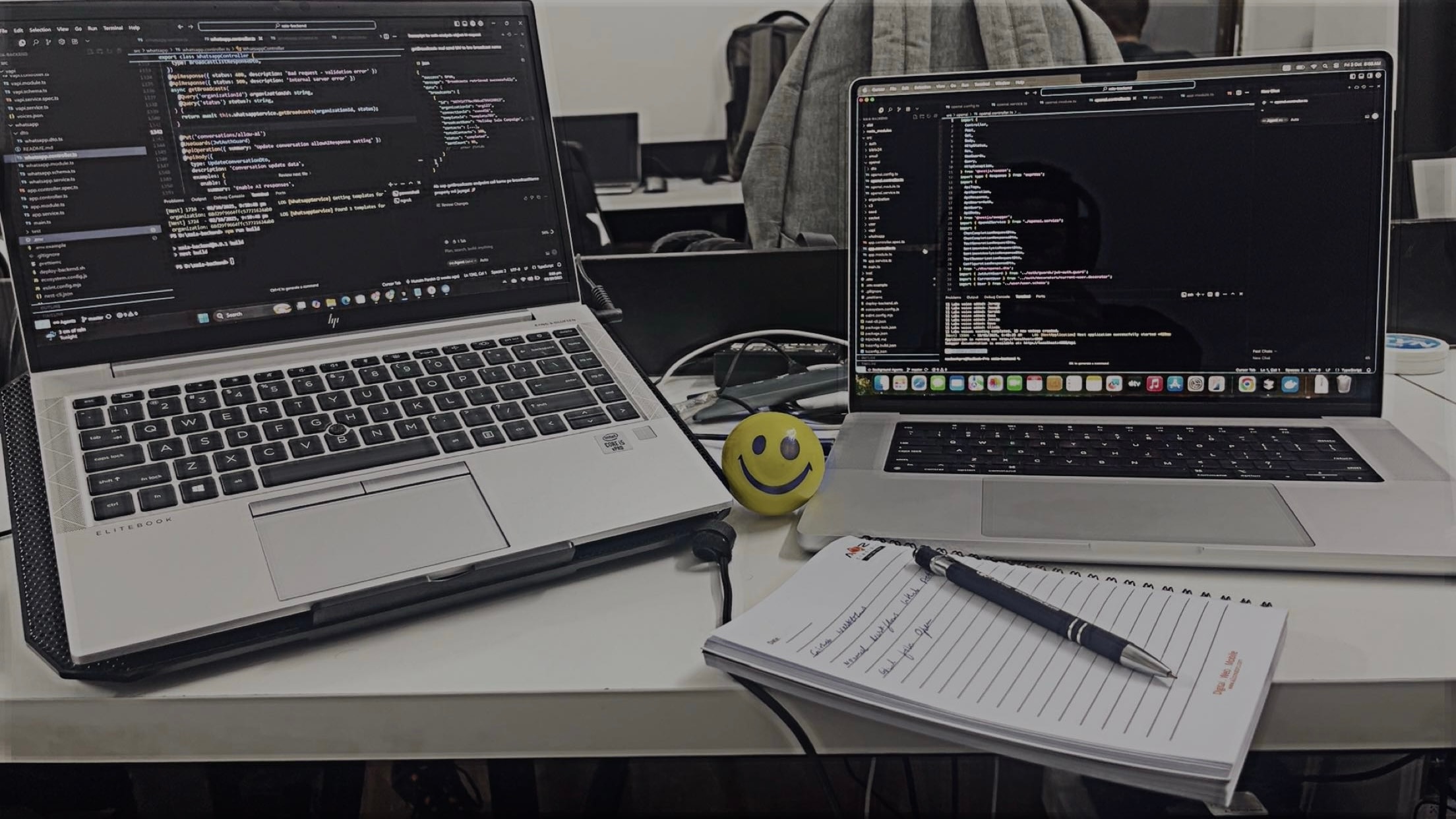 Dual laptop coding setup with notes